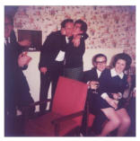 Tom Ryan sitting down, with Mrs. Rooney doing the kissing and Mr. Rooney clapping hands